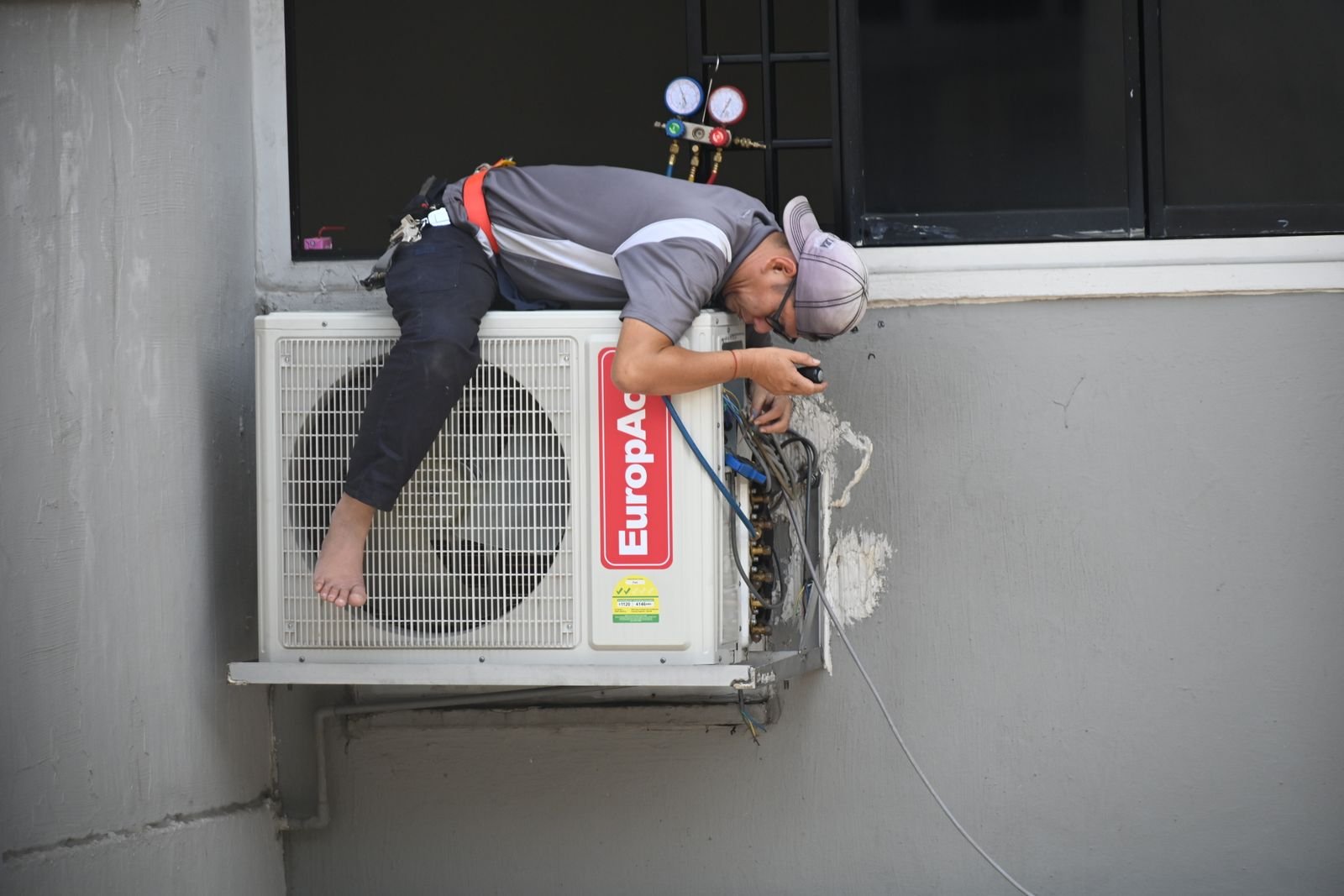 Technician installing an AC unit